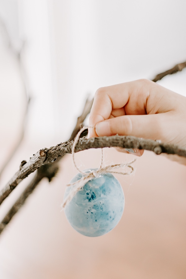 Hanging plastic eggs on an Easter Tree