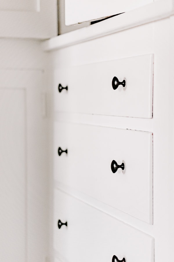 Black matte knobs can elevate the look of a plain white linen closet