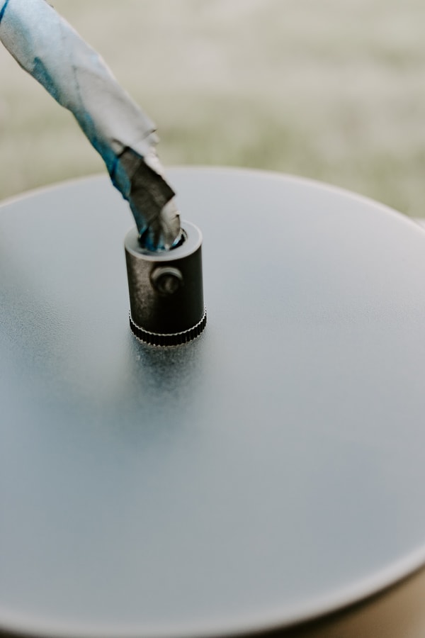 close up of a light fixture being spray painted.