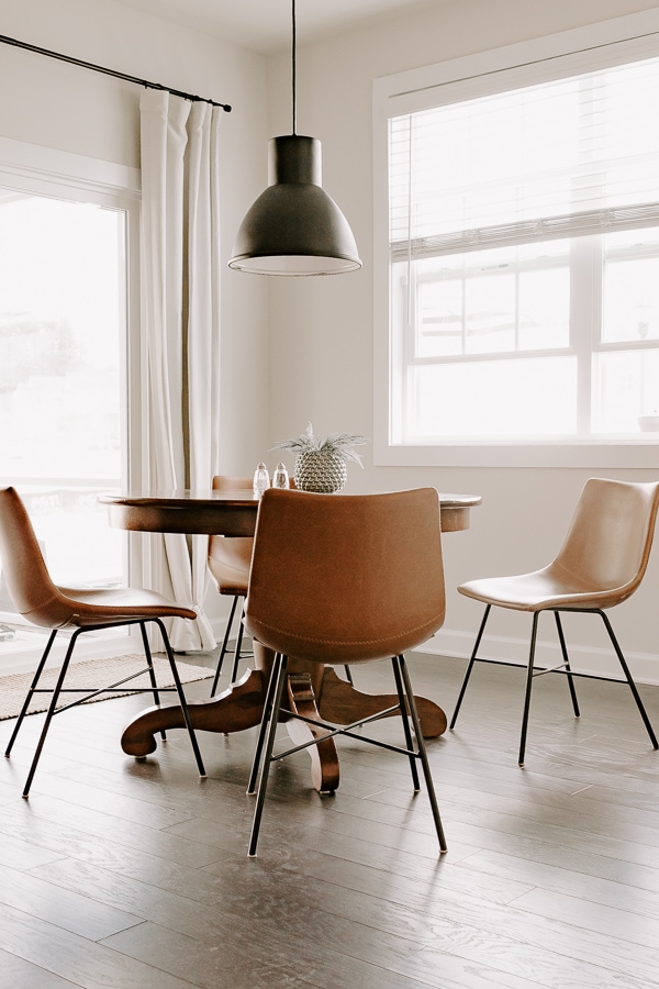 black light fixture, leather chairs and a round table, breakfast nook