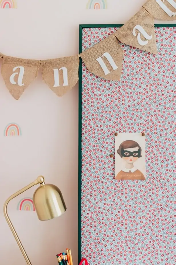 How to Make a Fabric Pinboard - Decor Hint A painted pin board with floral fabric fabric on a white desk - learn how to make a fabric pin board