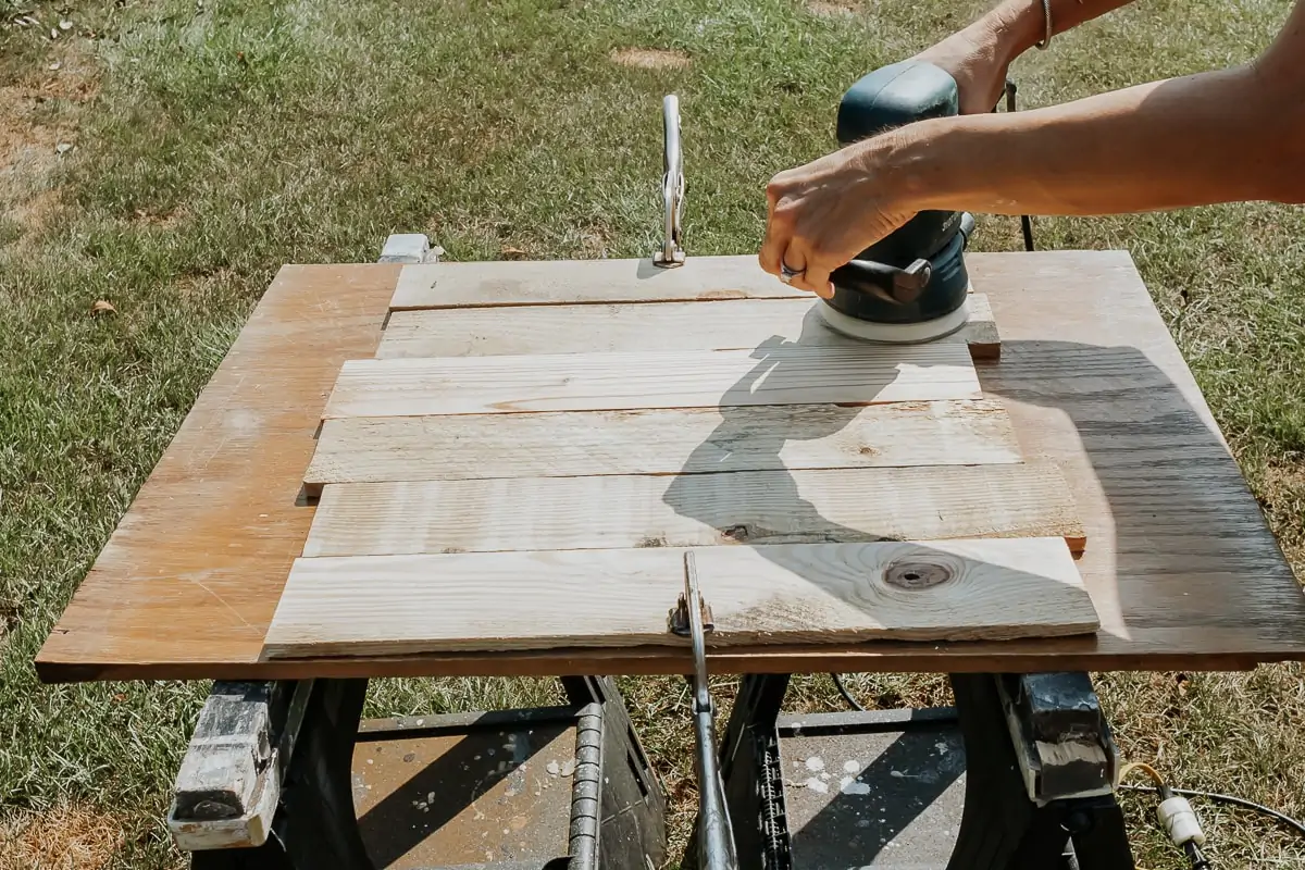 Pretty DIY Wood Lanterns - Decor Hint sanding old pallet wood