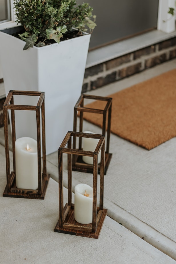 Pretty DIY Wood Lanterns - decorhint a set of three DIy Wood Lanterns on a front porch