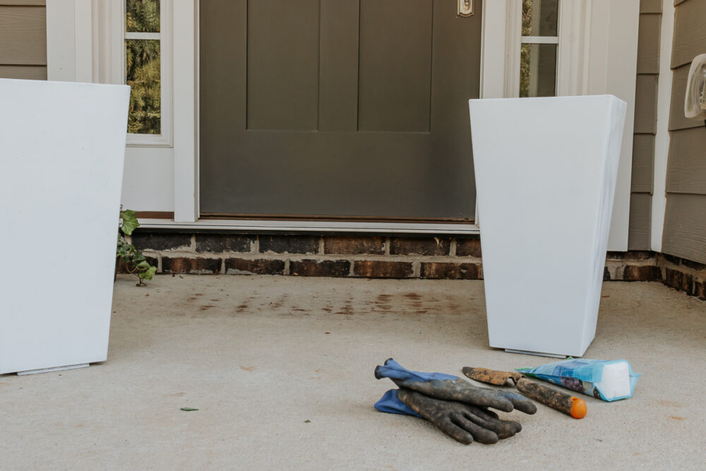 white plastic planter pot on front porch - how to paint outdoor planters - full tutorial in post