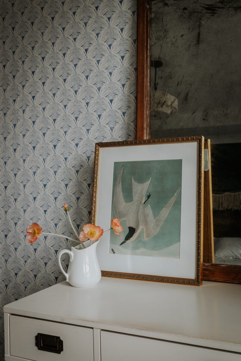 thrifted frames with a bird painting in them