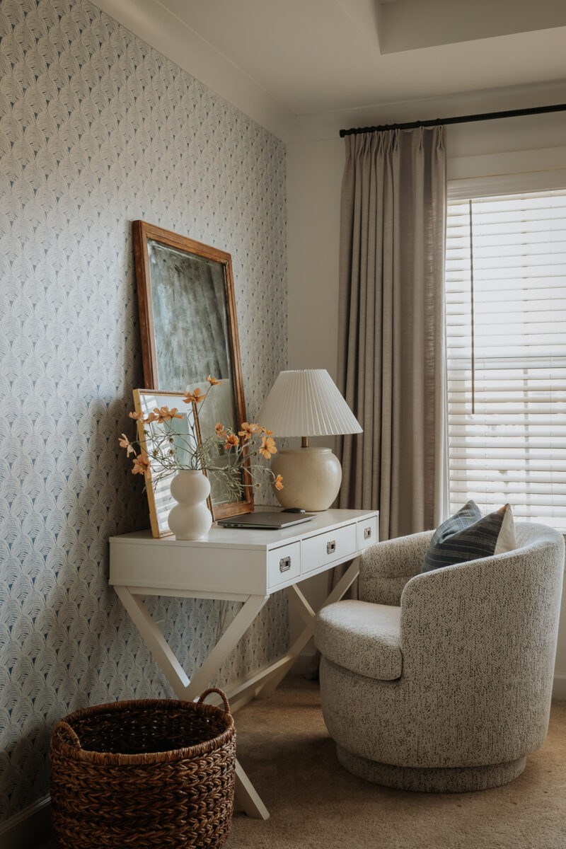white desk in a room with gray curtains and a white and gray chair with a basket