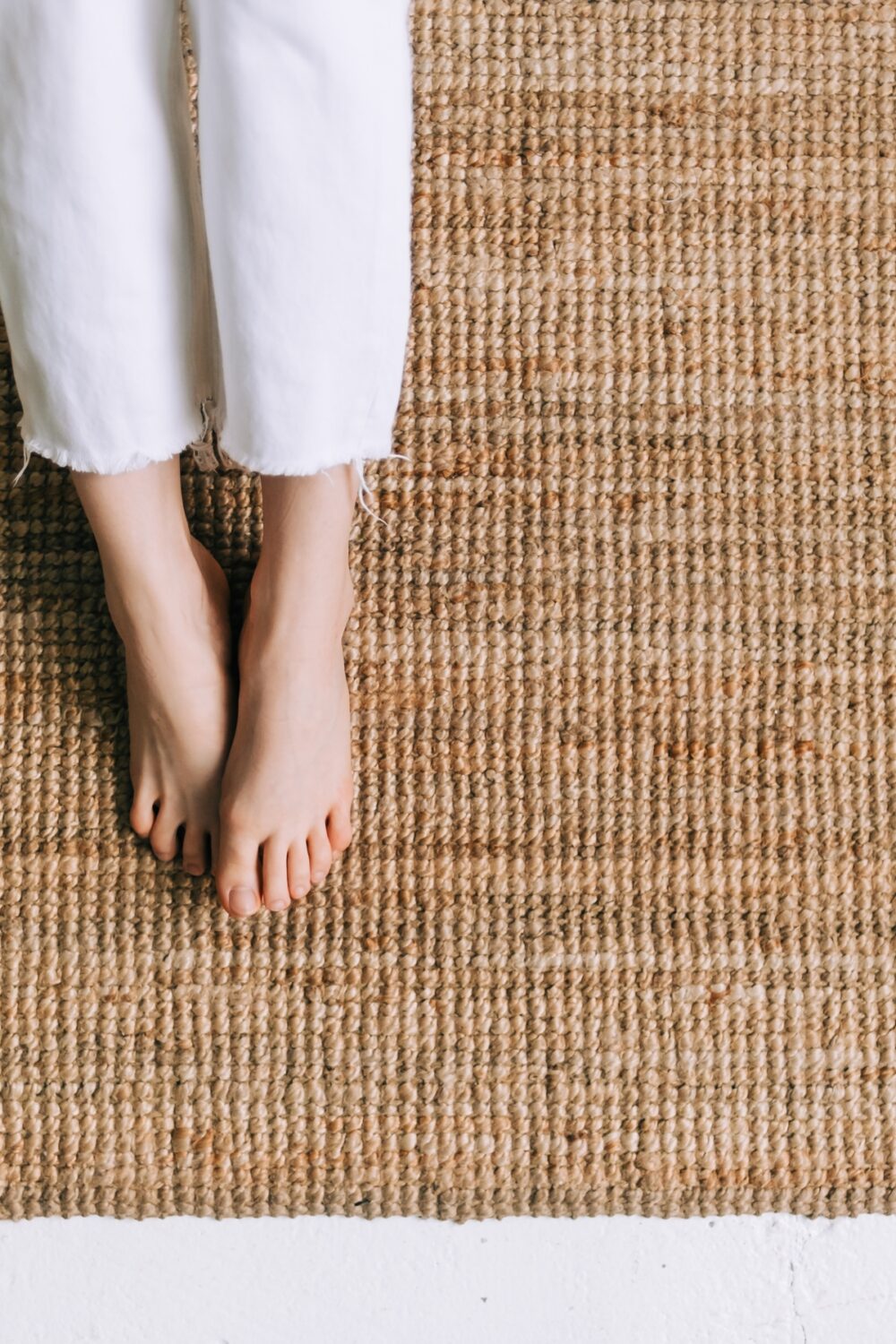 image of bare feet on a jute rug