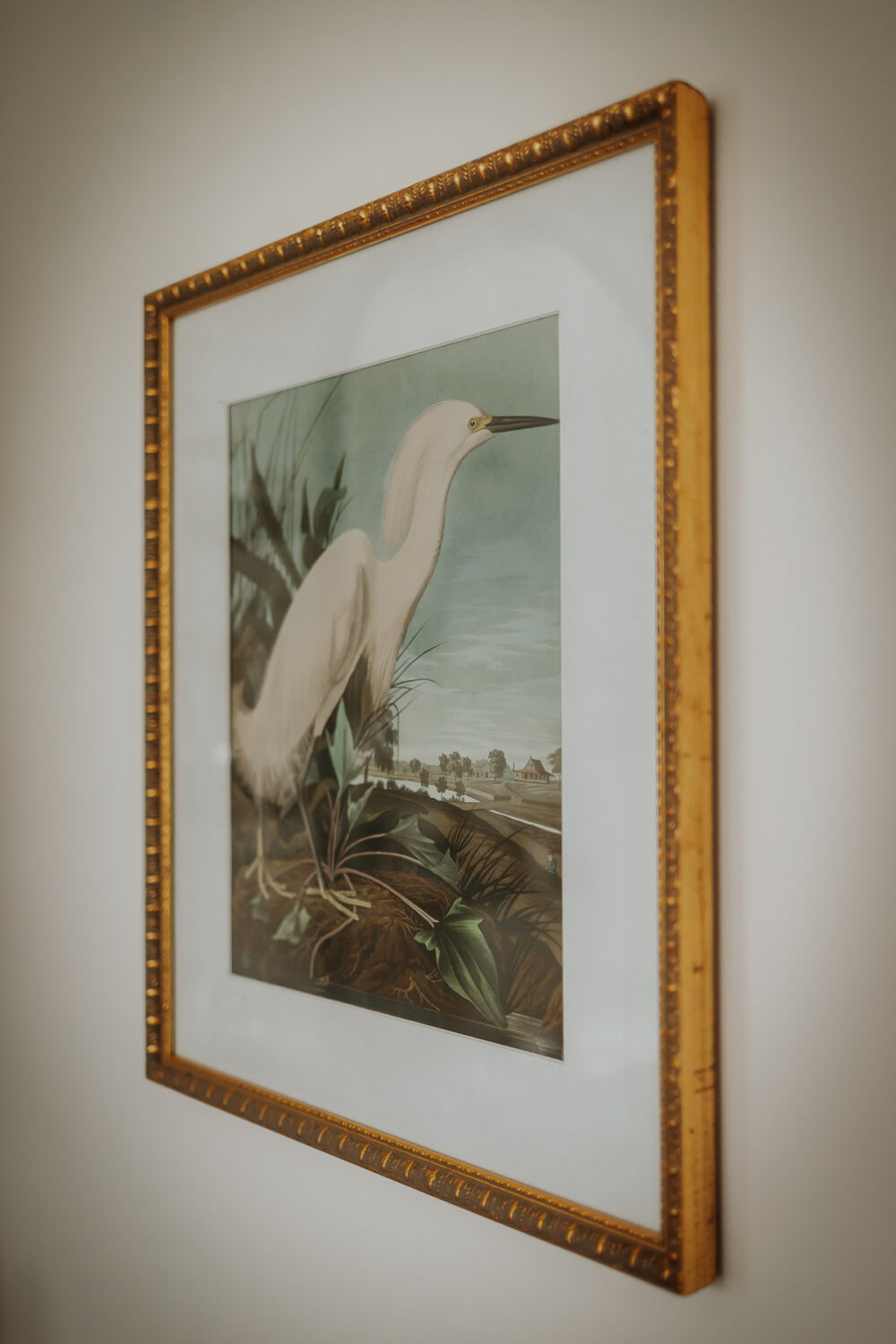 close up view of a thrift store frame with new art in it and a spray painted white mat