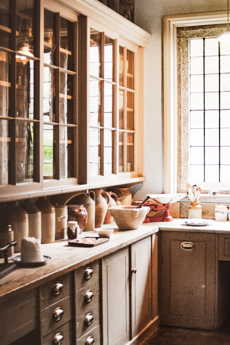 A kitchen with wood cabinets and bowls out on the counter