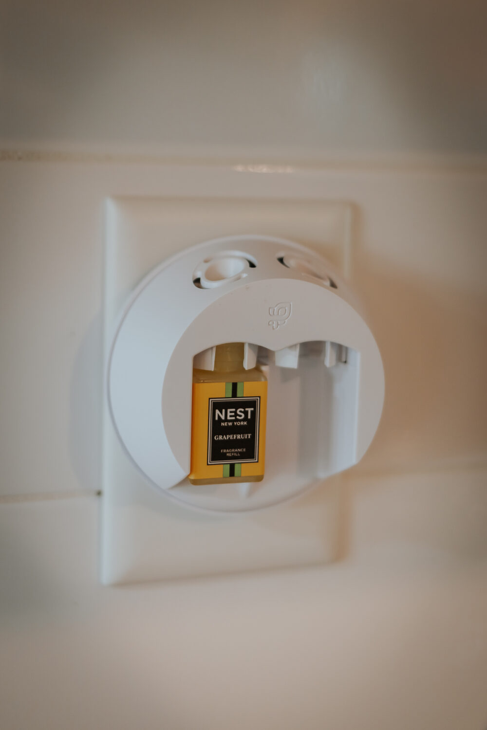 Pura Diffuser Review - Is It worth the Hype? - Decor Hint pura 4 plugged into the wall with a nest fragrance in it