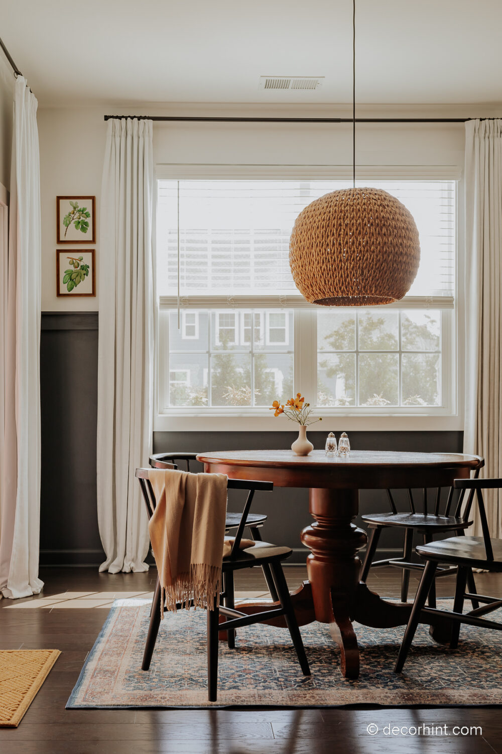 Breathe Life into Your Breakfast Nook with These Easy Ideas - Decor Hint breakfast nook with chair rail, white drapes and a rattan chandelier