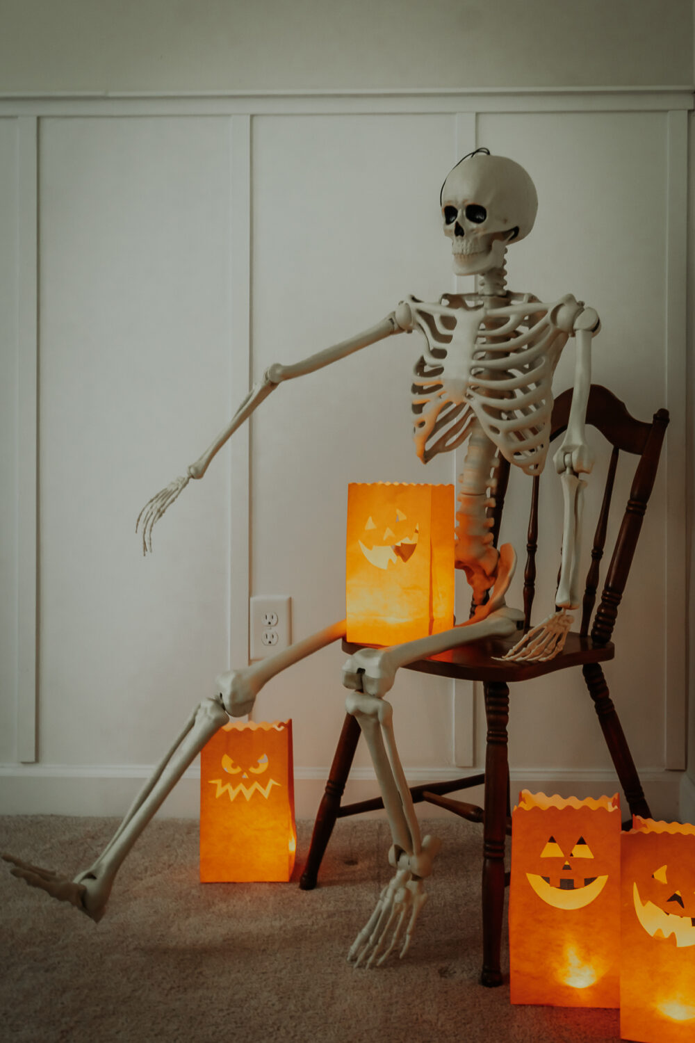 Halloween Luminary Bags with candles next to a Skeleton - Decor Hint