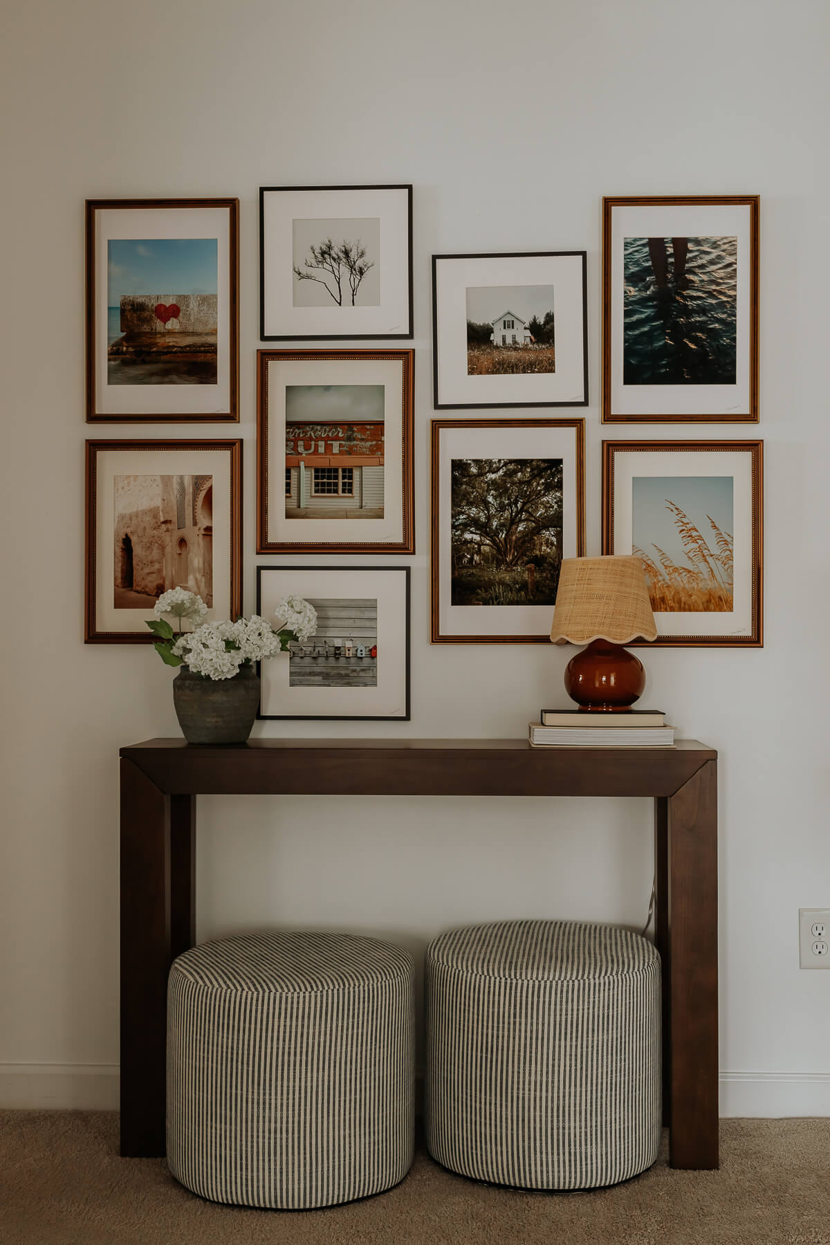 A Cozy Hallway Refresh: New Finds from Wayfair - Decor Hint Hallway refresh featuring striped poufs, a warm scalloped-shade lamp, a stylish gallery wall, and a rich walnut wood console table.