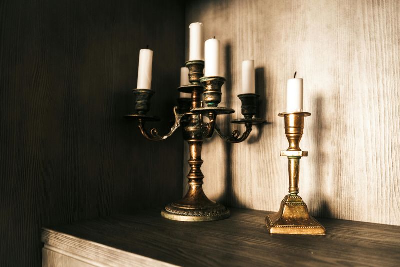 9 Cheap Things To Thrift That Can Actually Make Your Home Look More Expensive - Decor Hint Brass Or Metal Candleholders That Gleam