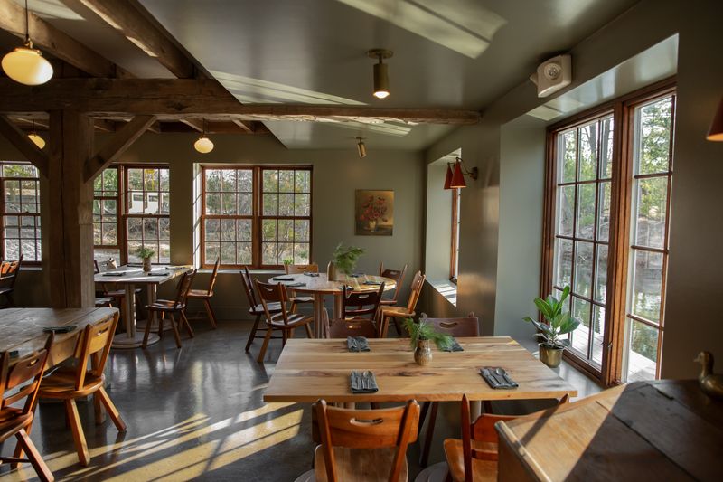 12 Restaurants In Michigan Offering Lakeside Views And Amazing Food - Decor Hint Supper At The Mill - Glen Arbor