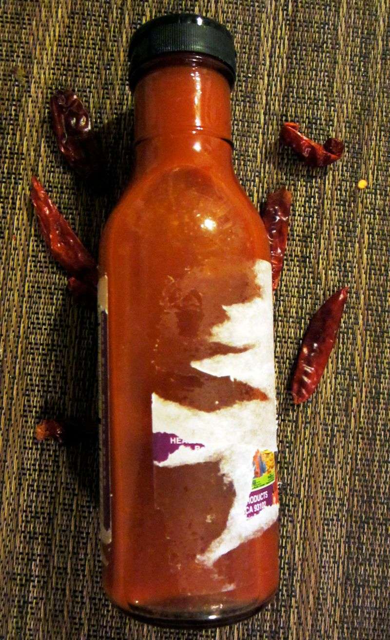 20 Subtle Clues At California Mexican Restaurants You Might Miss - Decor Hint House-Made Hot Sauce Bottles on Table