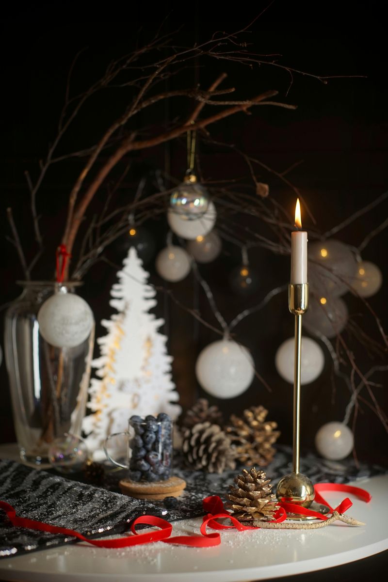 8 Rustic Fall Centerpieces To Warm Up Your Family Table - Decor Hint Glass Vase Of Branches With Hanging Acorns Or Tags