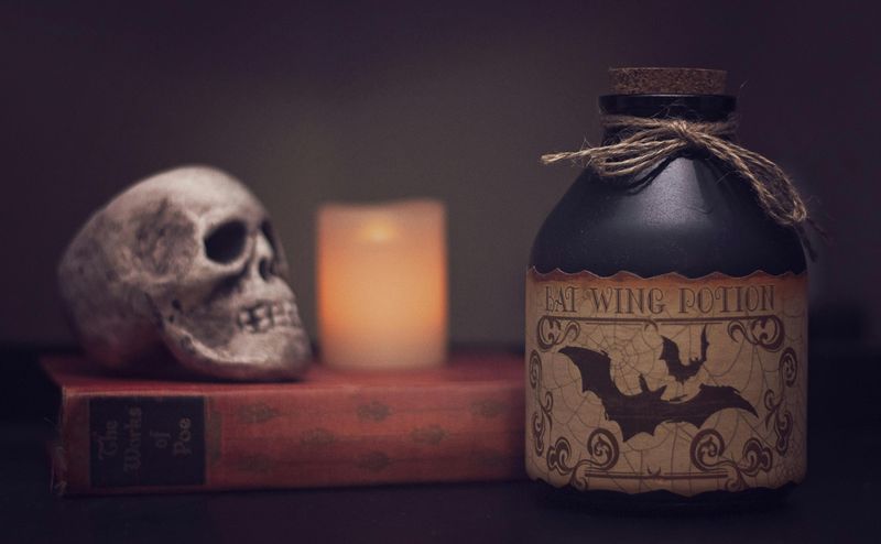 7 Chic Indoor Halloween Decorations That Skip The Tacky Look - Decor Hint Apothecary Jars with Faux Potion Labels