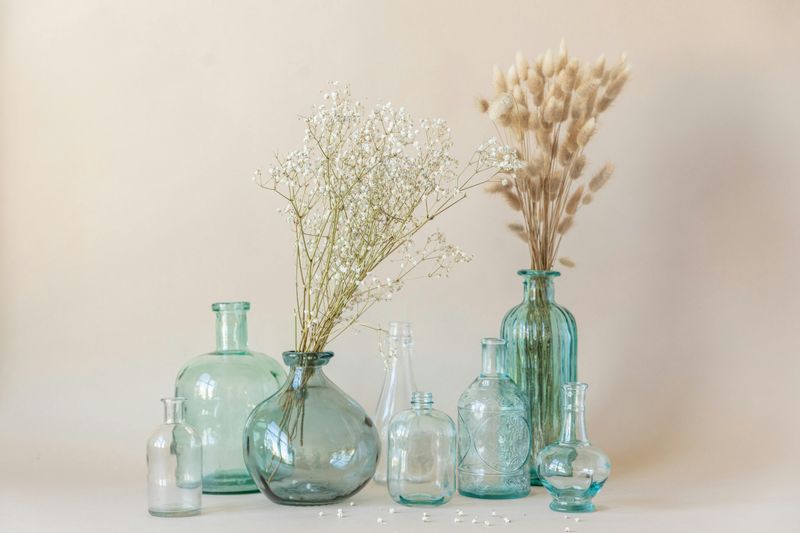 11 Cozy Halloween Decor Ideas That Work All Season Long - Decor Hint Vintage Glass Bottles with Seasonal Flowers