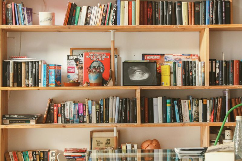 13 Hiding Spot Ideas That Could Help Keep Valuables Secure - Decor Hint Behind Books On A Shelf