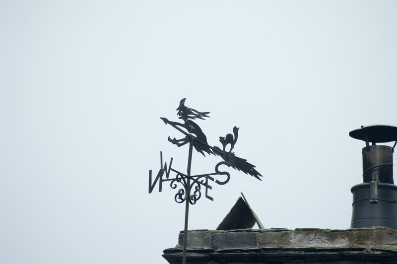 Witches On Broomsticks Silhouetted Against The Sky