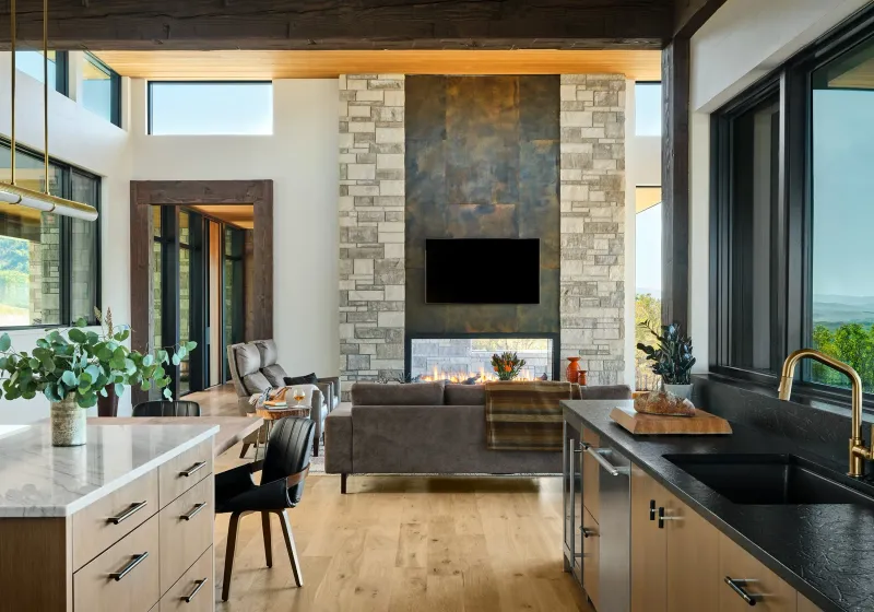 Dual-Purpose Kitchen And Living Area With Shared Fireplace