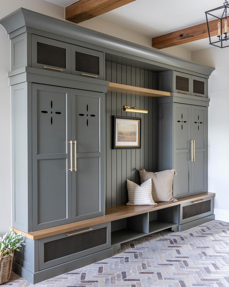Mudroom Built-In With Brass Accents And Herringbone Brick Floors