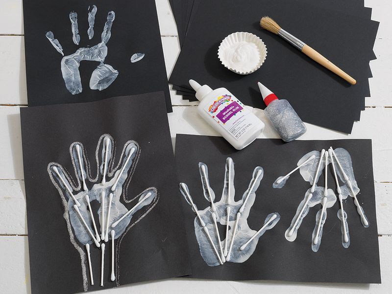 Handprint Skeletons On Black Paper