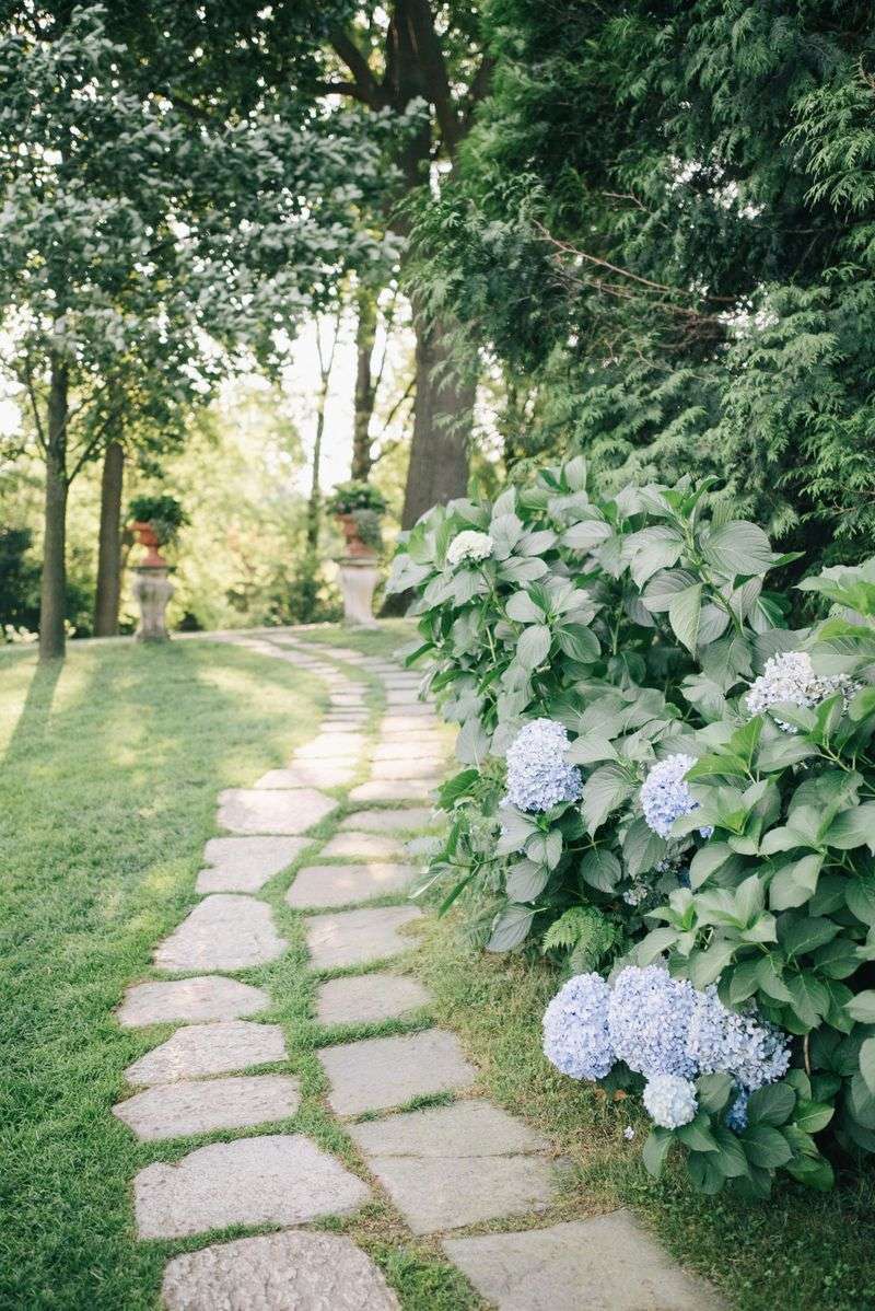 5 Ways To Make Your Yard Seem Bigger Without Moving Walls - Decor Hint Create curved pathways instead of straight lines