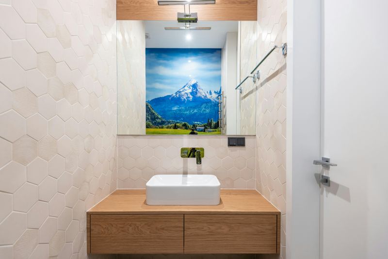 16 Ideas That Could Help Your Tiny Bathroom Look Larger - Decor Hint Hang Artwork Higher