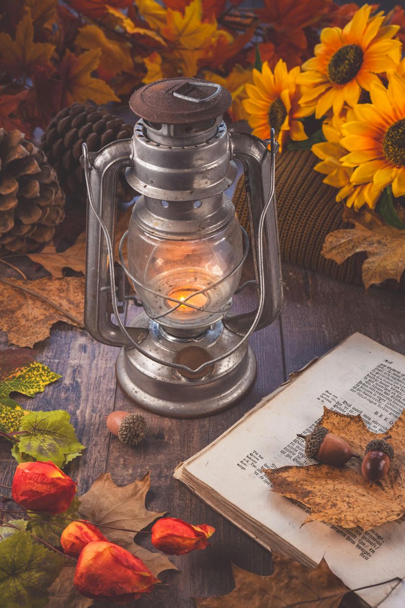 8 Rustic Fall Centerpieces To Warm Up Your Family Table - Decor Hint Antique Lanterns Surrounded By Autumn Leaves