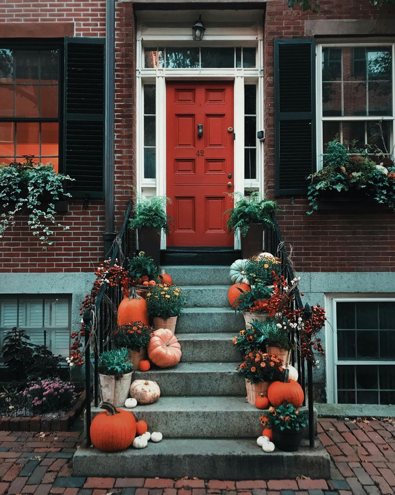 10 Porch Pumpkin Arrangements That Feel Classic Not Cheesy - Decor Hint Mini Pumpkins on Stair Steps