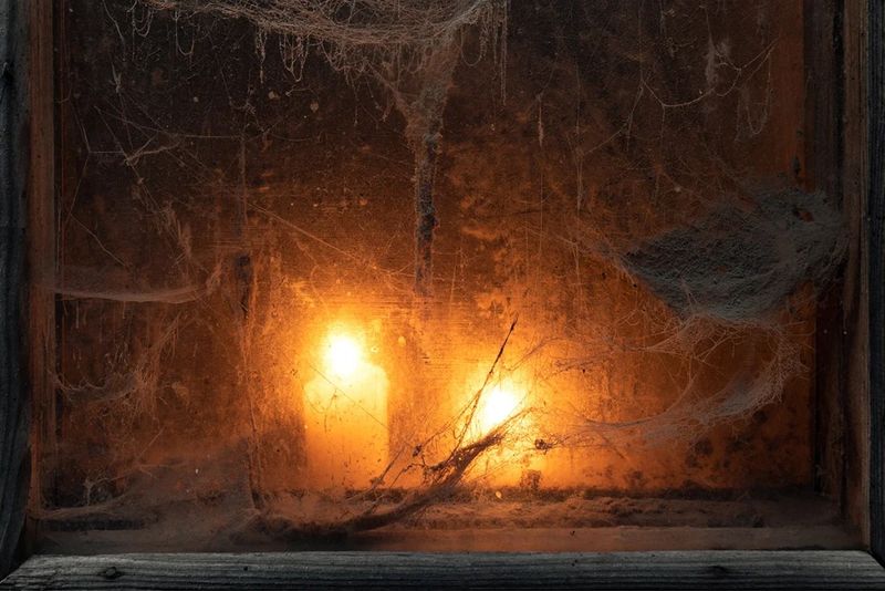 15 Garage Makeovers Turning Ohio Homes Into Haunted Havens - Decor Hint The Classic Haunted Mansion With Candlelit Windows