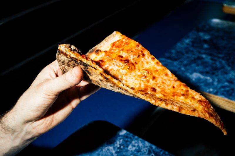 New York Foods Locals Can't Live Without - Decor Hint Thin-Crust Pizza Slice