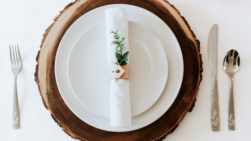 Thanksgiving Table Ideas Californians Are Using To Blend Fall And Christmas Decor - Decor Hint Wooden Chargers With Evergreen Napkin Rings
