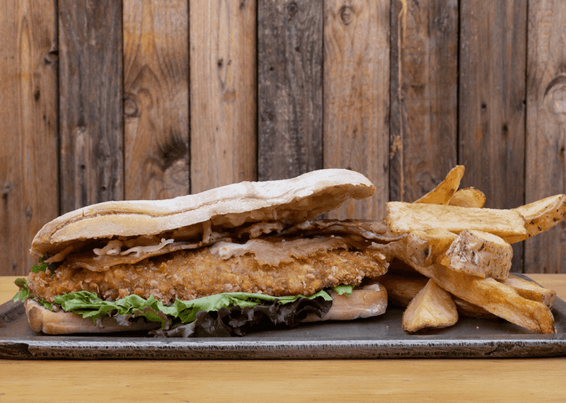 20 Massive Pork Tenderloin Sandwiches In New England You'll Need Two Hands To Tackle - Decor Hint The Constitution Cutlet at Liberty Lunch - Hartford, Connecticut