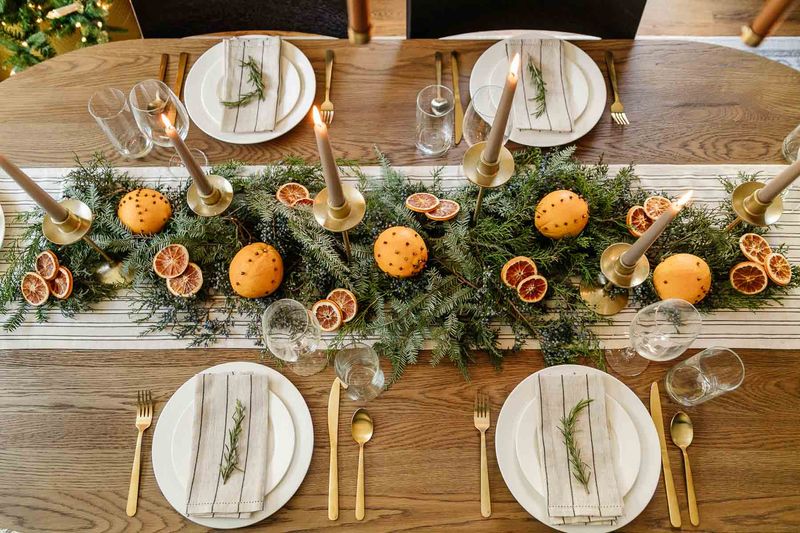 Thanksgiving Table Ideas Californians Are Using To Blend Fall And Christmas Decor - Decor Hint Mixed Greenery Centerpiece With Citrus And Berries