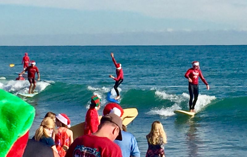 Hundreds Of Costumed Surfers Take The Waves