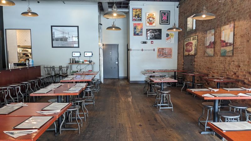 Why Locals Travel Across North Carolina For This Legendary Chicken Sandwich - Decor Hint The Warm Atmosphere Of Downtown Raleigh Dining