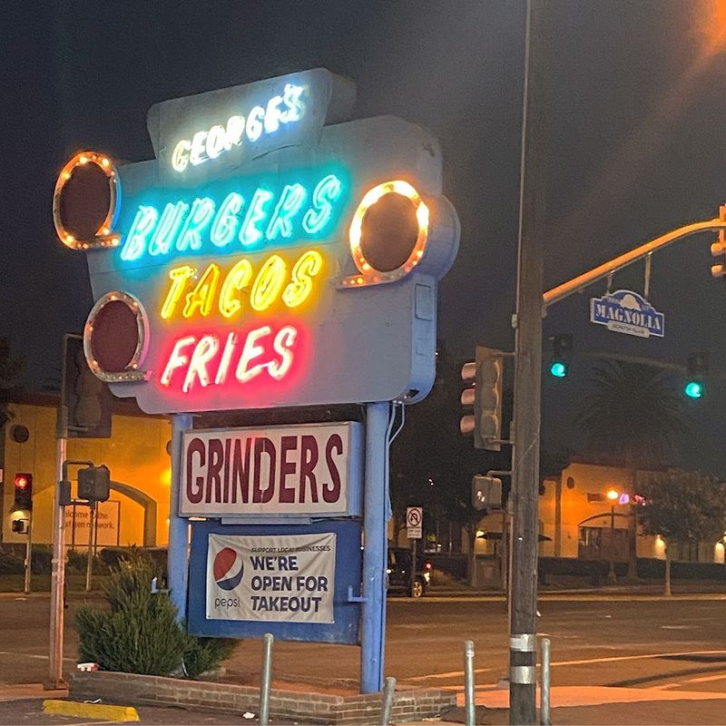 The Iconic Neon Sign And Blue Beams Are A Visual Landmark