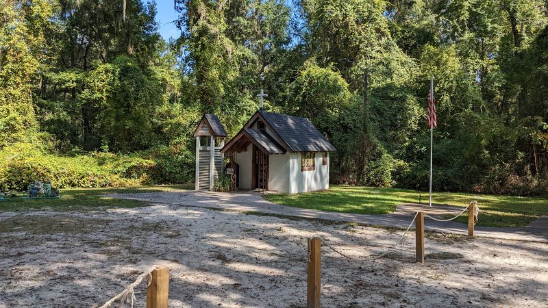 This Georgia Landmark Is Famous For Being The Smallest Church In America - Decor Hint Grounds Decorated With Statues and a Proud Flagpole
