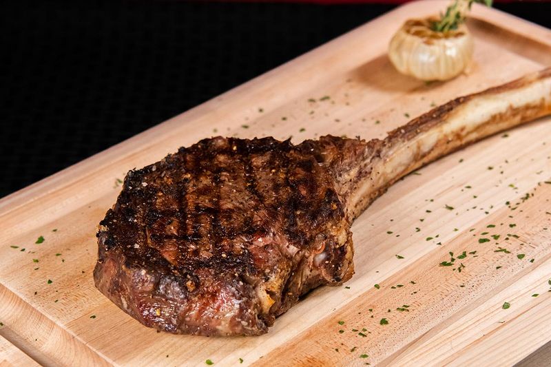 The Bone-In Ribeye At This North Carolina Steakhouse Is So Good, It's Worth A Drive - Decor Hint That First Slice Explains Why Locals Talk About It