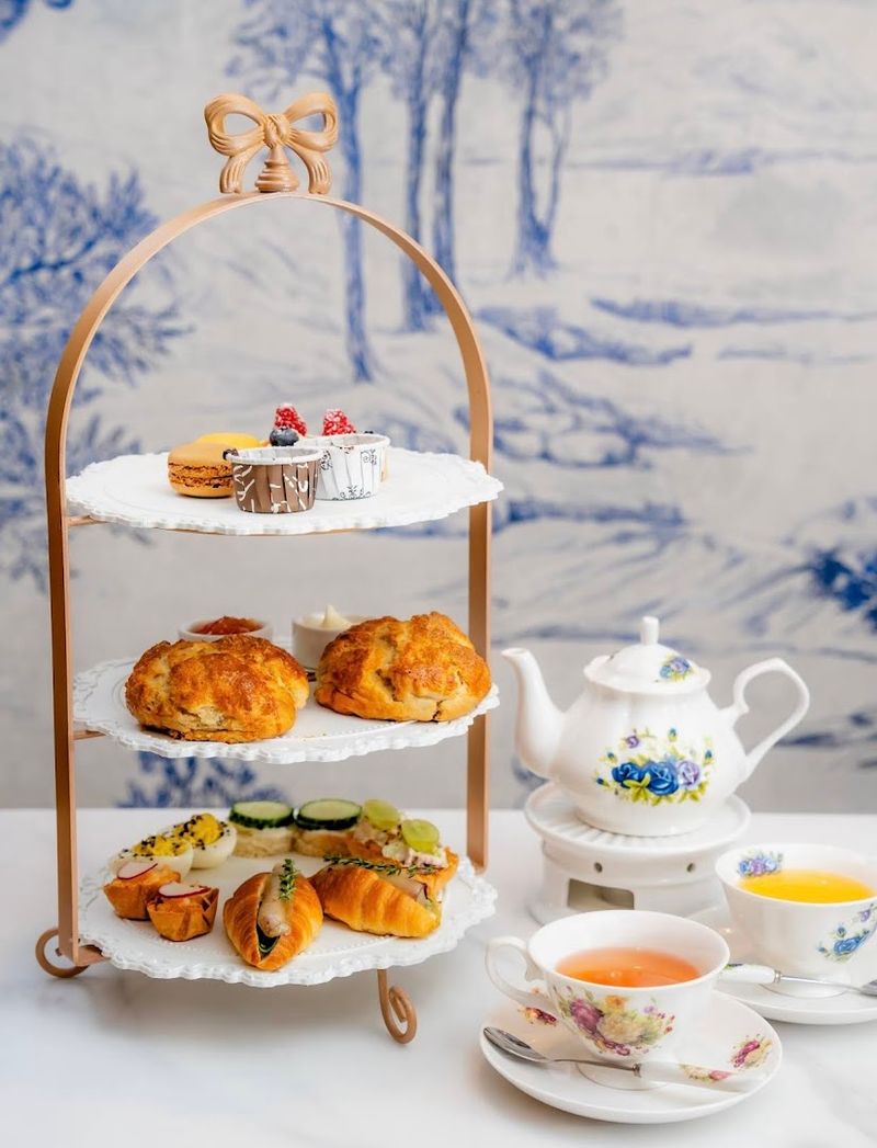 Scones, Sandwiches, And Sweets Fill The Tiered Trays