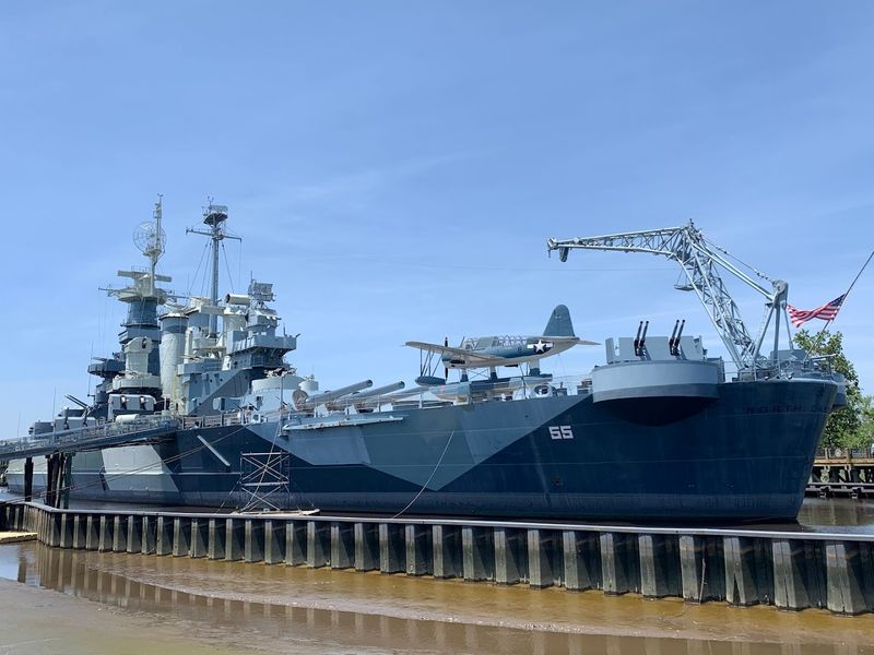 The Battleship Glows In Patriotic Colors At Sunset