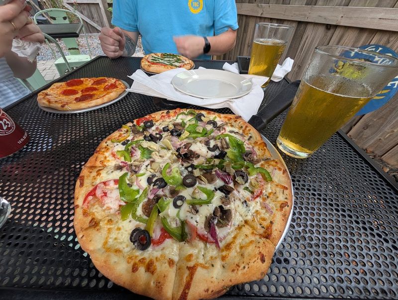 This Southeastern North Carolina Pizza Spot Serves Brick-Oven Pizzas Under The Southport Water Tower - Decor Hint Fresh Pies Keep The Local Crowd Coming Back