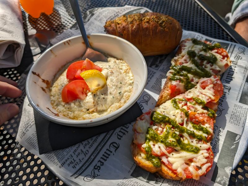 This Southeastern North Carolina Pizza Spot Serves Brick-Oven Pizzas Under The Southport Water Tower - Decor Hint The Menu Goes Beyond Pizza In A Good Way