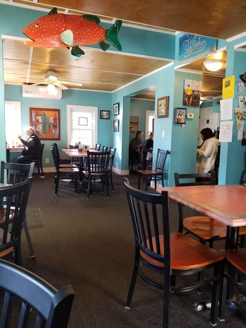 This Southeastern North Carolina Pizza Spot Serves Brick-Oven Pizzas Under The Southport Water Tower - Decor Hint Local Art Adds Something Unexpected To The Walls