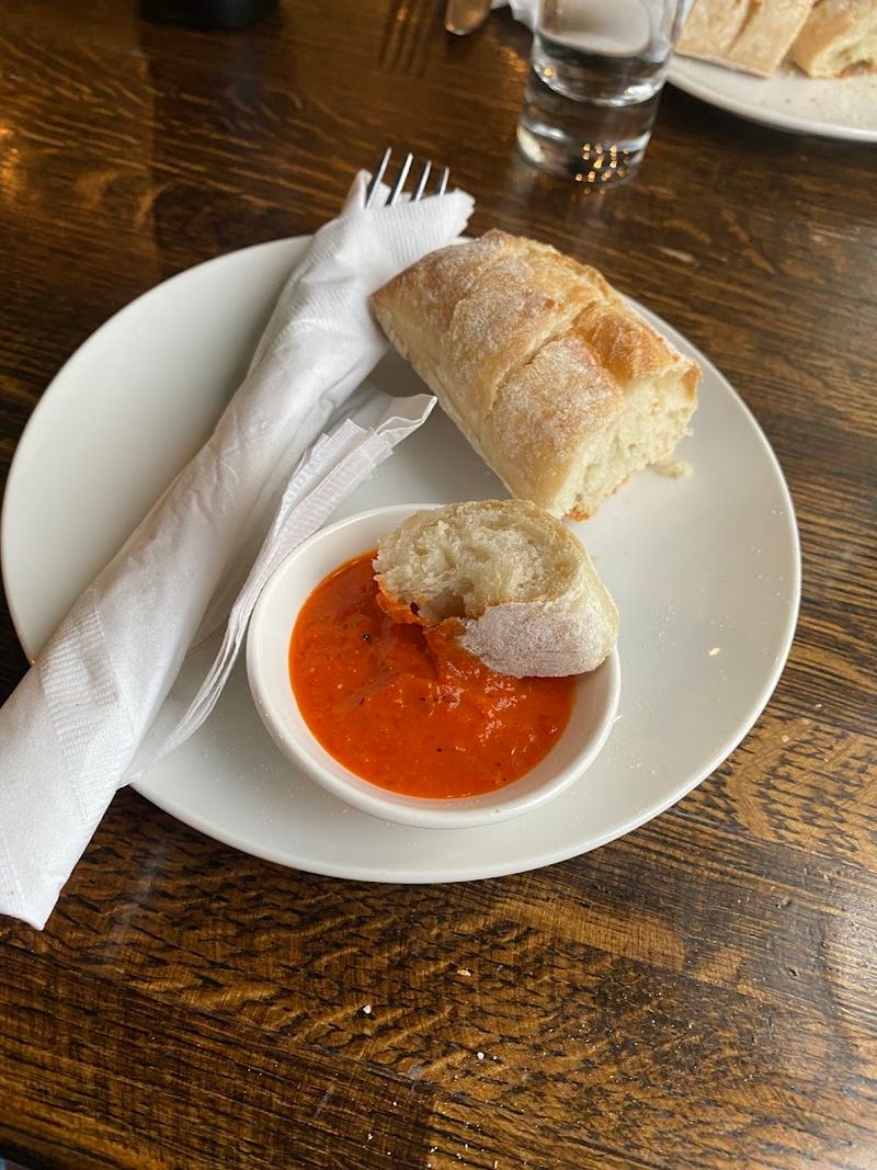 Fresh-Baked Bread And A Pepper Sauce That Guests Take Home In Jars