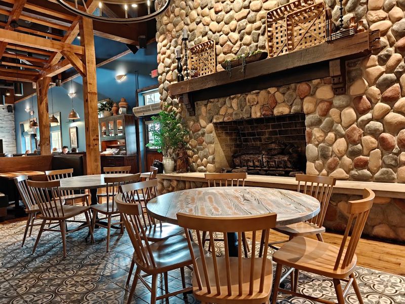 This Charming Indiana Restaurant Lets You Dine Beneath Towering Sycamore Trees - Decor Hint The Stone Fireplace That Anchors The Entire Dining Room