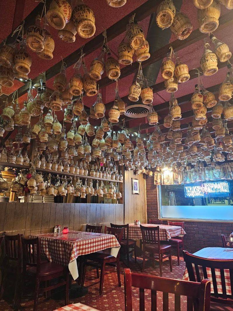 Look Up At The Chianti Bottles Hanging From The Ceiling
